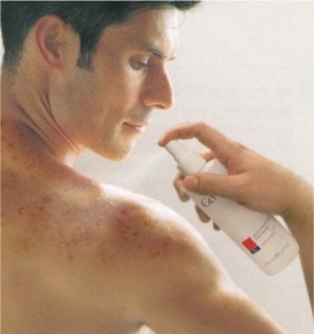 What_Causes_Back_Acne_and_How_Can_You_Get_Rid_of_It man spraying back